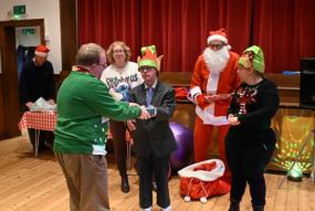 Mencap members receive presents at Christmas party